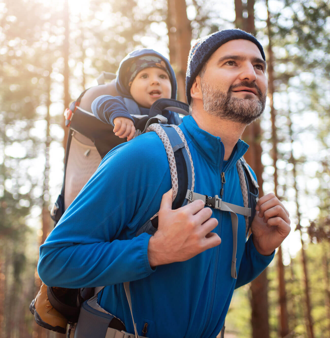 Father hiking in the woods with his baby boy.